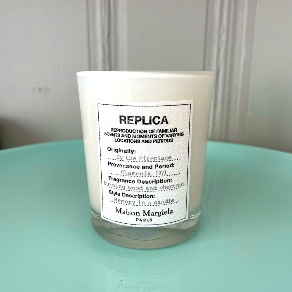 Replica by the fireplace candle